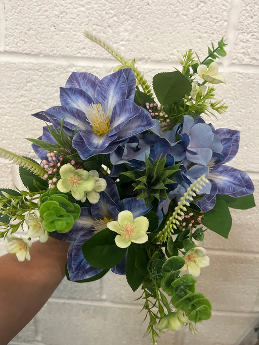 Purple blue clematis and hydrangea bush