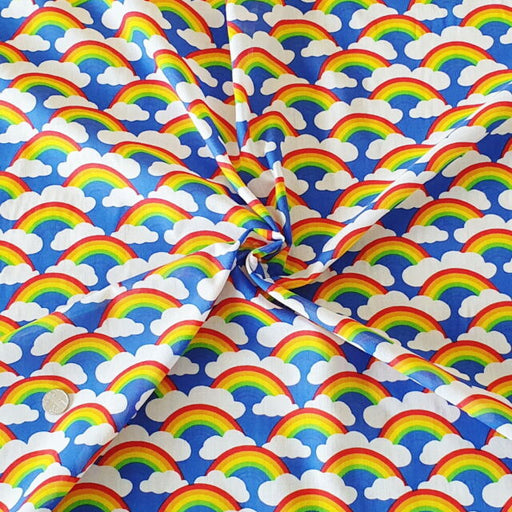 1 Metre Rainbows and Clouds Polycotton Fabric Royal Blue Background x 43"